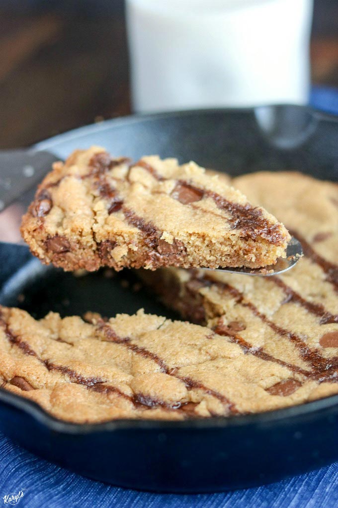 close up shot of skillet cookie with a wedge cut out so you can see the inside