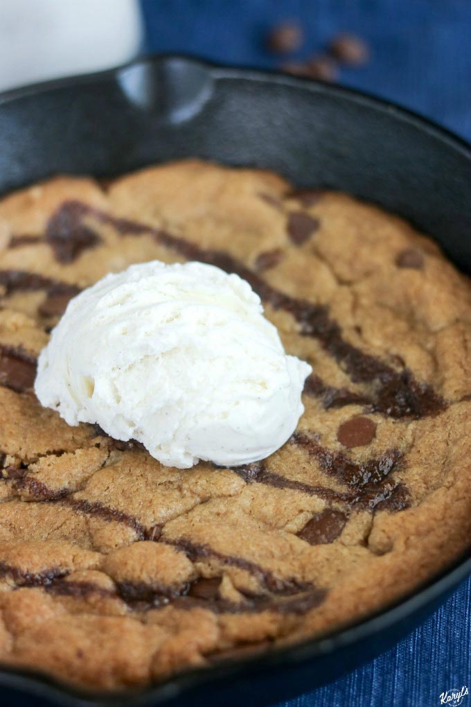 finished shot of skillet cookie drizzled with syrup and topped with scoop of ice cream