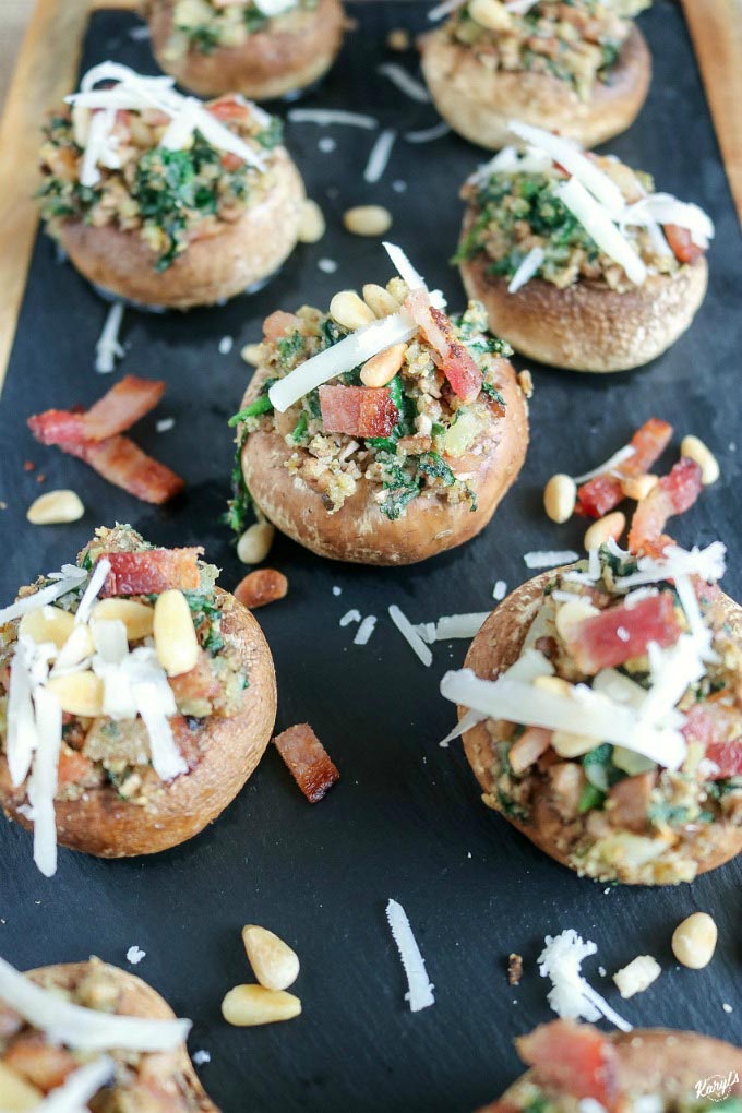 Spinach and Bacon Stuffed Mushrooms are a perfect party appetizer. Fill plump white mushroom caps with the easy, make-ahead filling, and they're fresh out of the oven in about 20 minutes #appetizer #easyappetizer #gamedayfood #tailgatefood #bitesized #mushrooms #stuffedmushrooms #spinach #bacon #pinenuts #karylskulinarykrusade