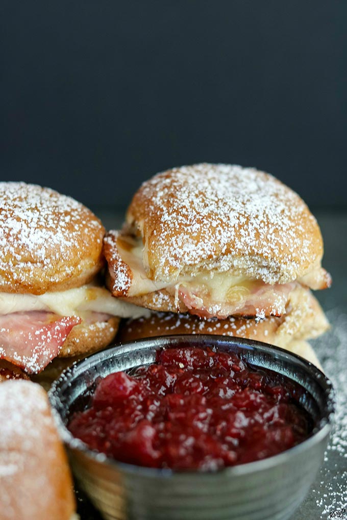 close up shot of finished Monte Cristo Sliders with a side of raspberry preserves