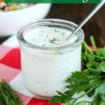 glass jar of coconut milk ranch dressing with a spoon in the jar
