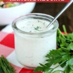 close up picture of a jar of coconut milk ranch dressing with a spoon in the jar
