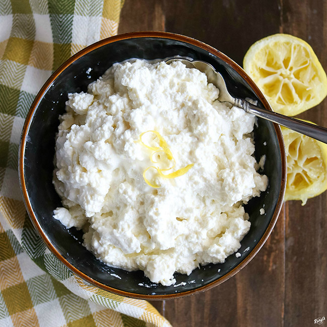 overhead shot of finished ricotta with lemon wedges on the right side