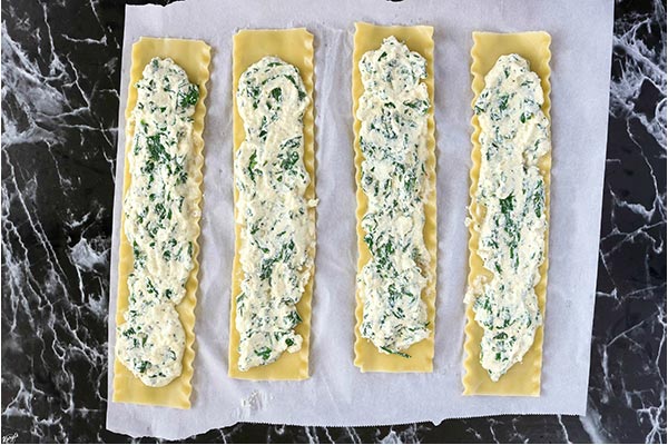 overhead process shot: lasagna noodles with spinach filling