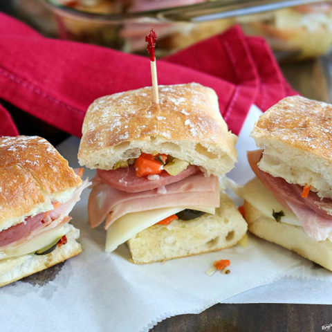 close up shot of finished Hot Muffaletta Sliders on white paper