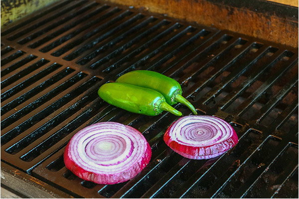 Process shot: jalapenos and red onions on the grill