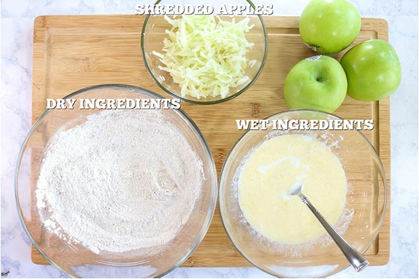 Overhead process shot: bowl of wet ingredients, bowl of dry ingredients, bowl of shredded apples