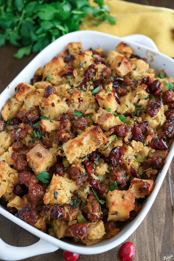 Close up shot of finished Sausage Sage Cranberry Stuffing in a white baking dish